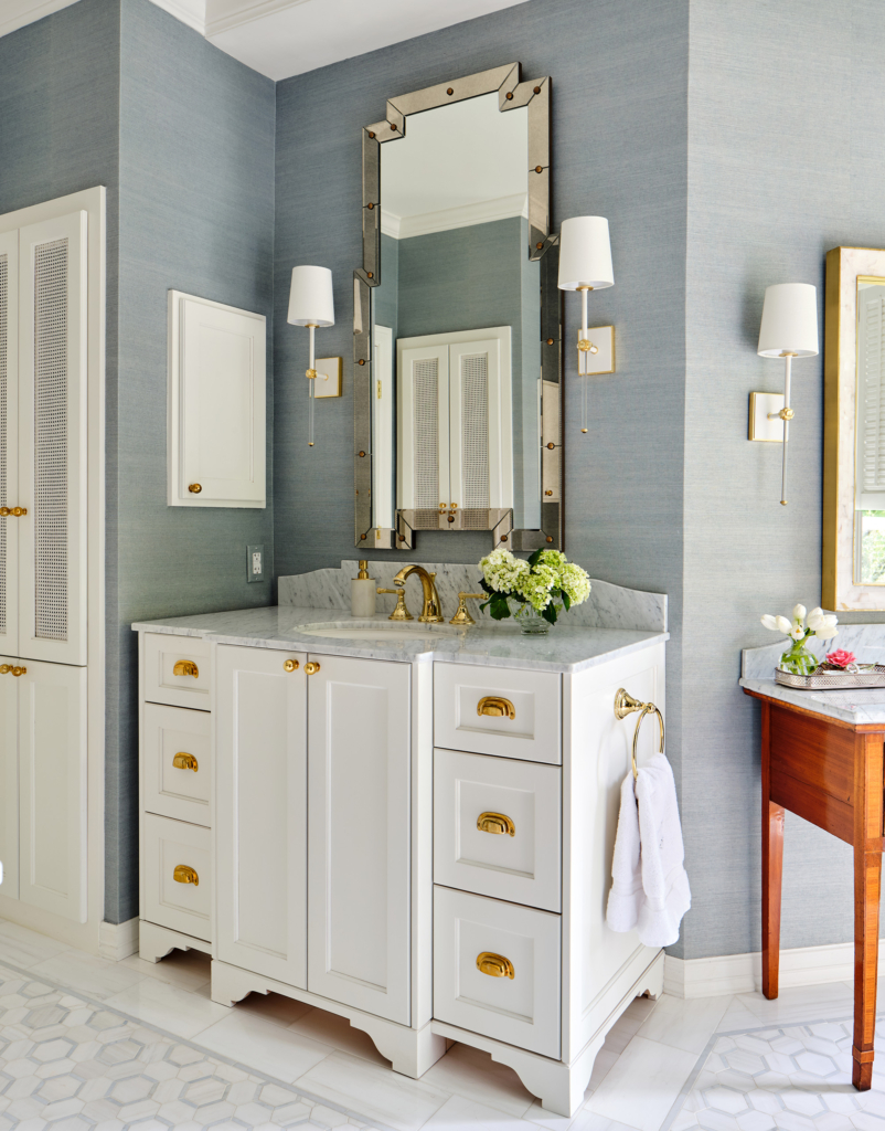 A silk-look (yet cleanable) wallpaper wraps the primary bath in serenity.