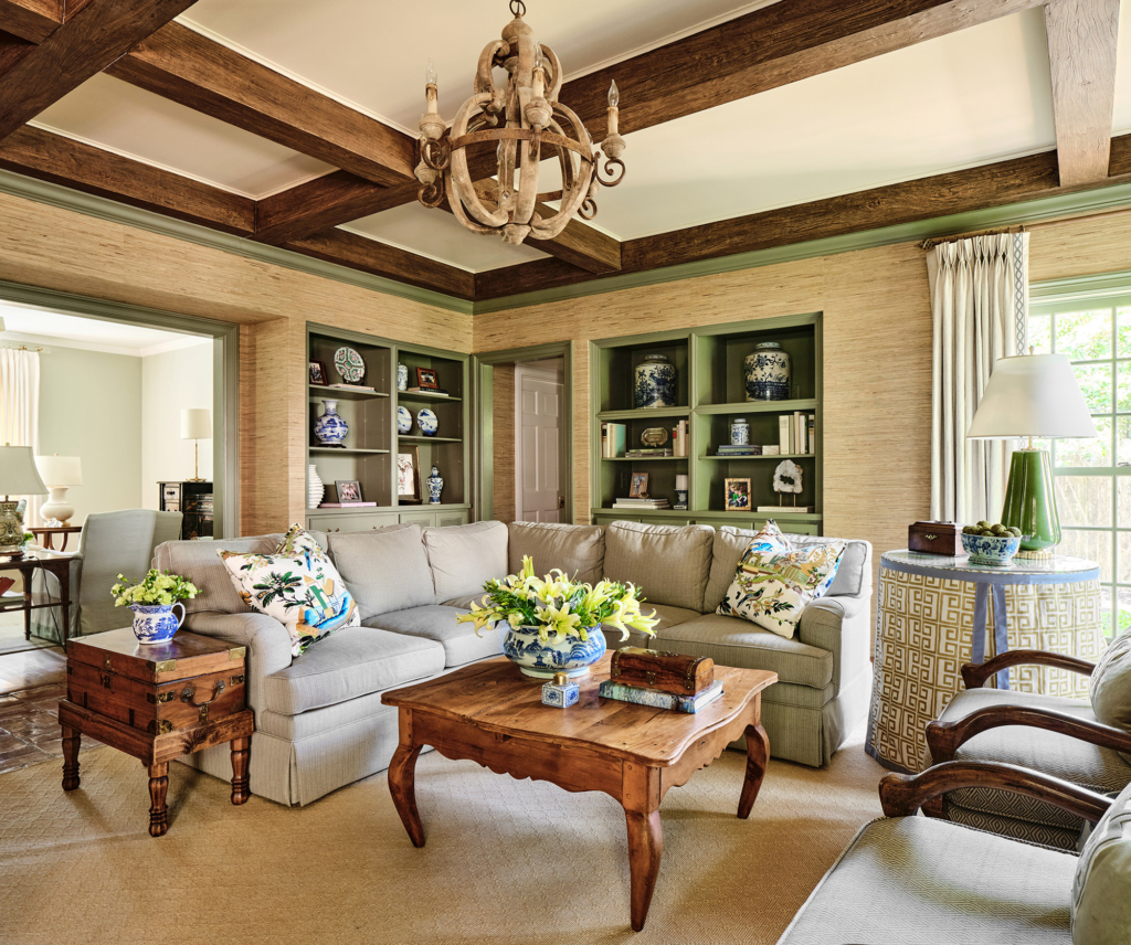 Green-painted built-ins feature some of the family's favorite books and collectibles.