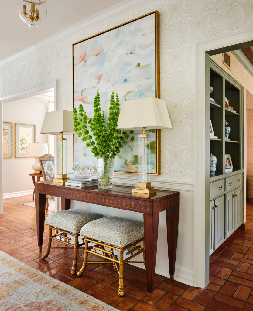 Art and accessories shine against the foyer's Galbraith and Paul "Lotus" wallpaper.