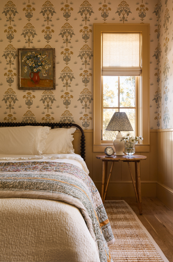 Yellow woodwork painted in Farrow & Ball "Sudbury Yellow" sets off the Morris & Co. "Meadow Sweet" wallpaper beautifully.