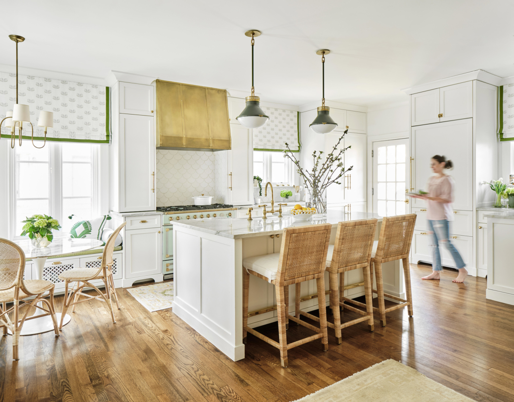 Fabulous kitchen with brass hardware, brass mesh inserts, and green details in this historic, European-inspired home.