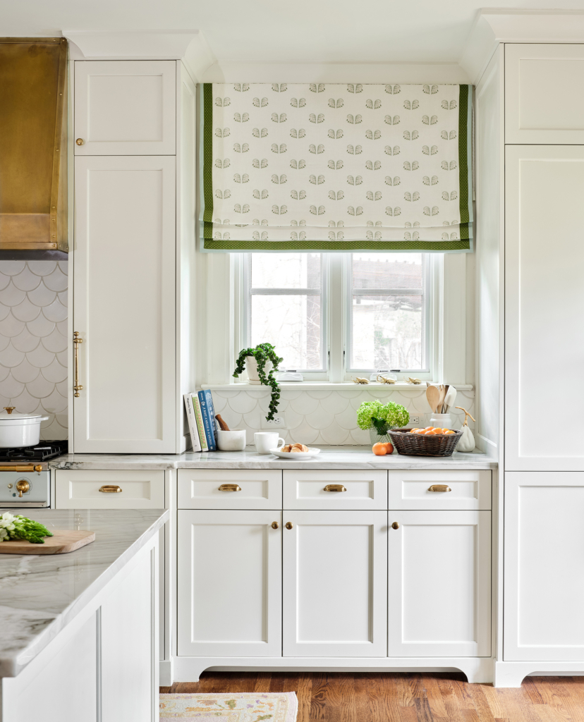 Custom drapery with green details in the kitchen contribute to the fresh, sophisticated vibe.