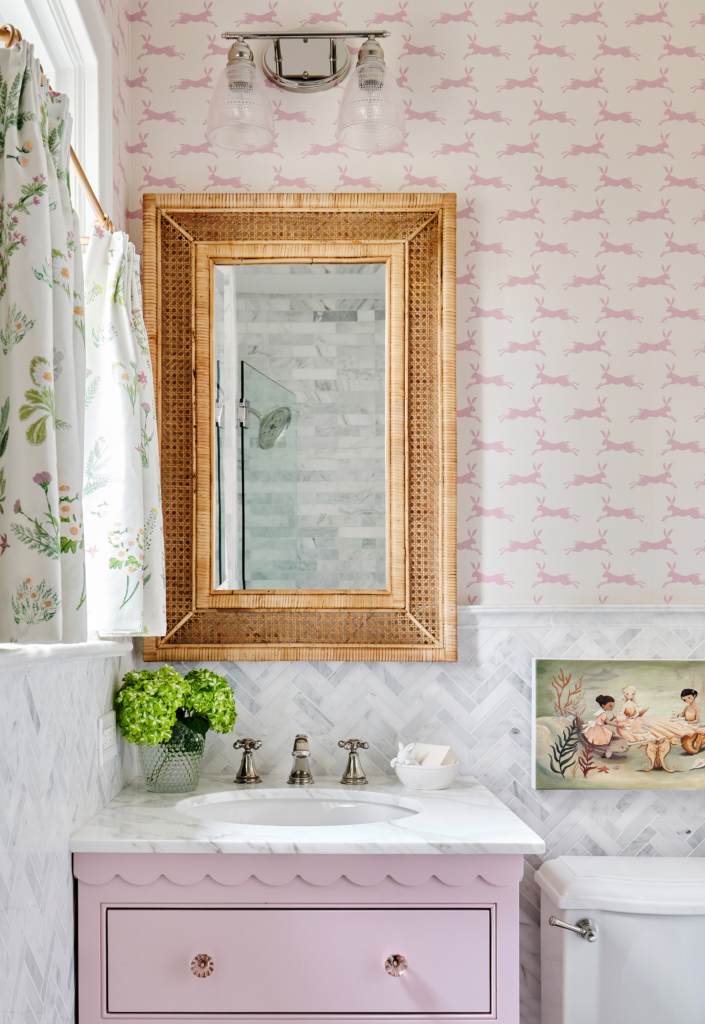 This fun "pink bunny" wallpaper enlivens a young girl's bathroom, complete with custom painted pink vanity! 