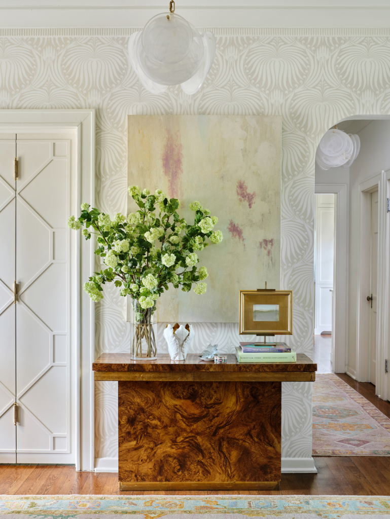We installed this Farrow and Ball wallpaper and painted the custom lacquered doors in this sophisticated entry.