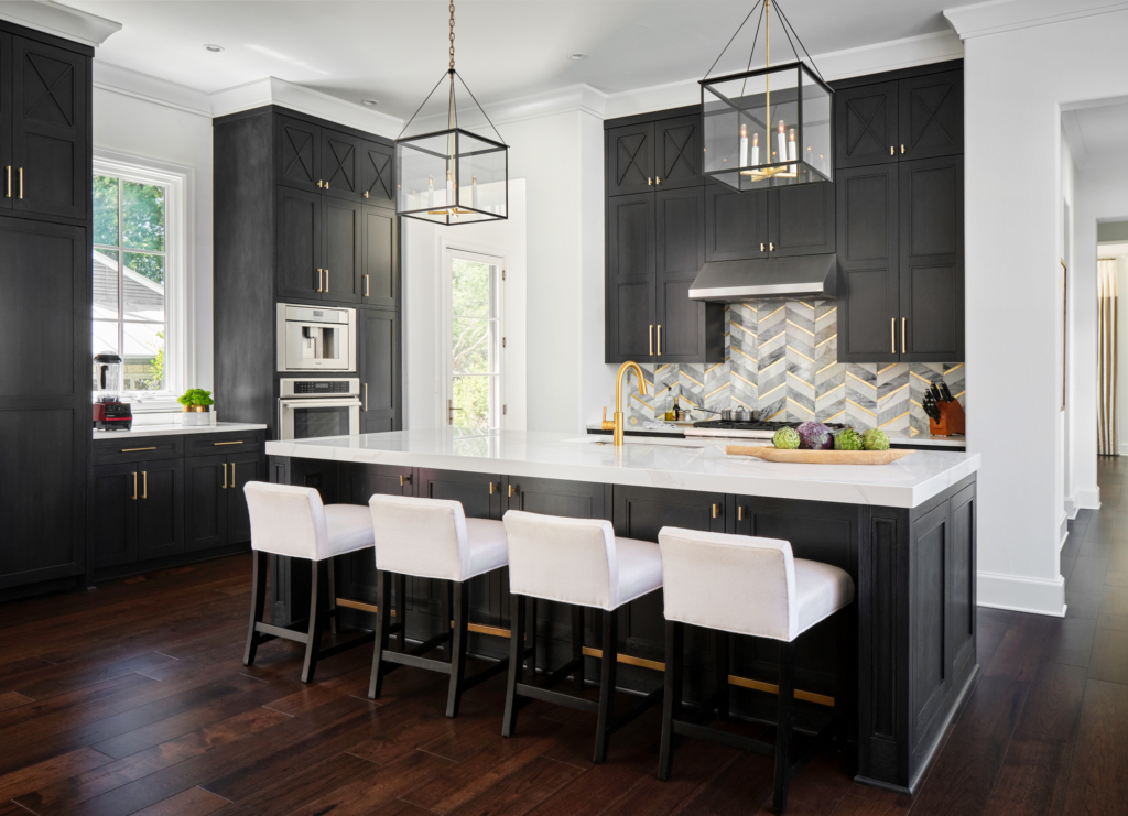 Modern edge meets artisan detail. These black kitchen cabinets in Benjamin Moore "Midnight Oil" feature a rich cerused finish that adds depth and texture.