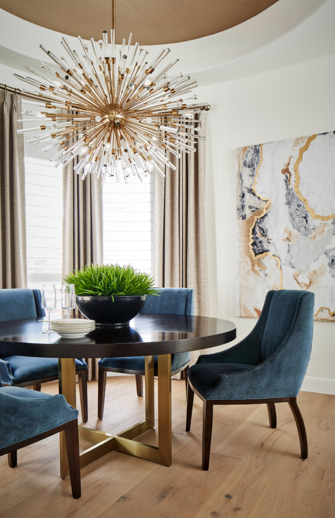 Breakfast area with a round table that echoes the wallpapered ceiling.
