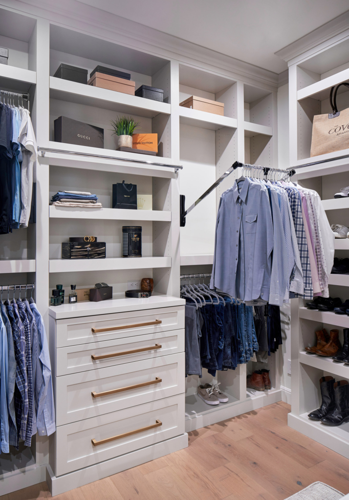 Men's closet area in the primary bedroom, with a pull-down rack for maximum efficiency.