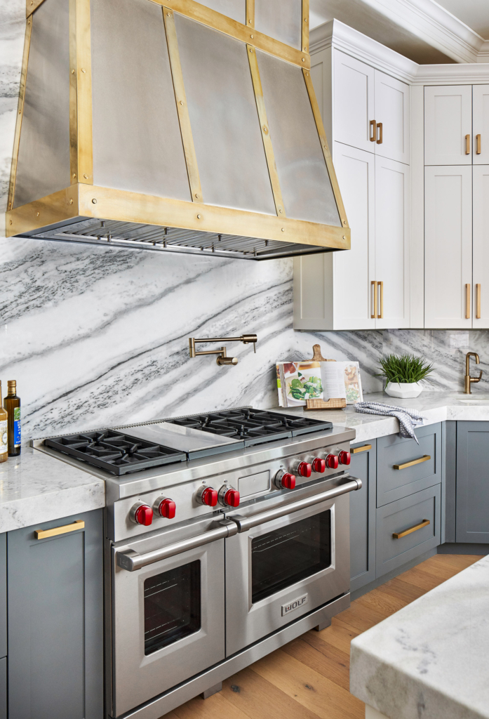The custom zinc and brass range hood is a stunning focal point in this kitchen.