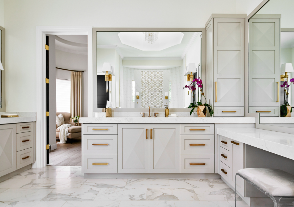 Bright and serene primary bath with white walls and light gray cabinets.