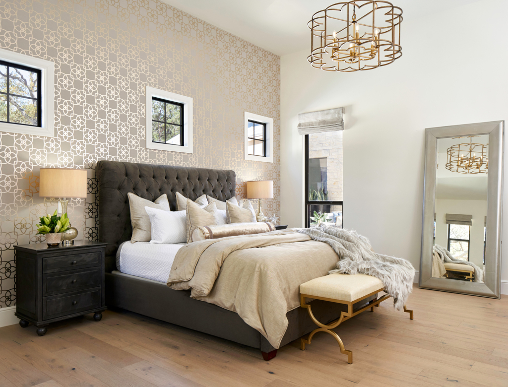 The primary bedroom's wallpaper contributes to the rich, glamorous vibe.