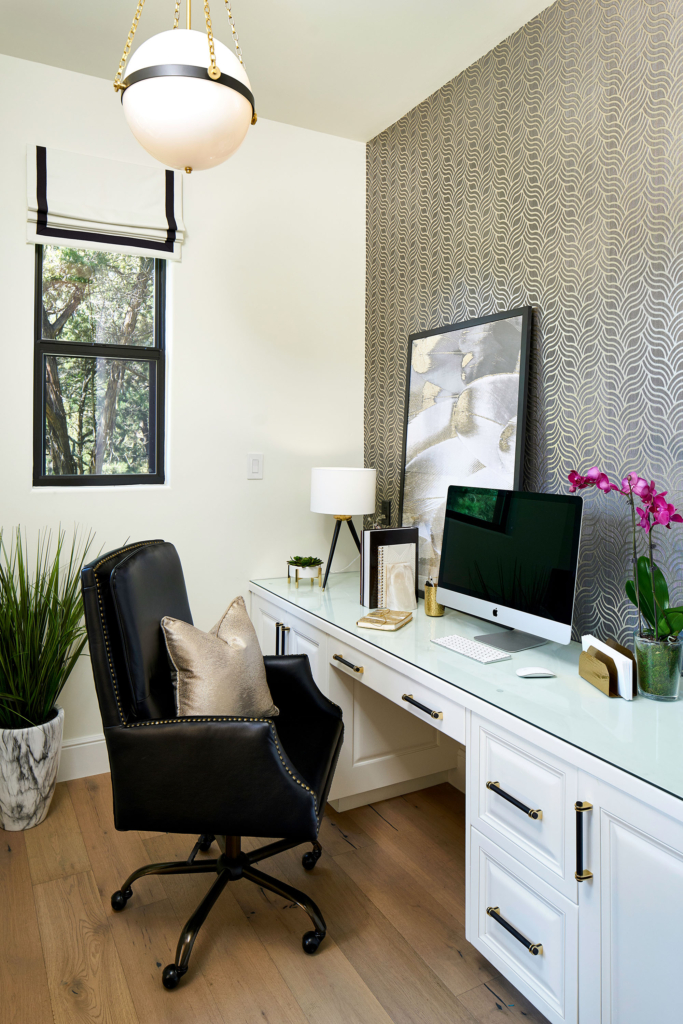 The updated home office, with a custom painted built-in desk and a wallpapered feature wall.