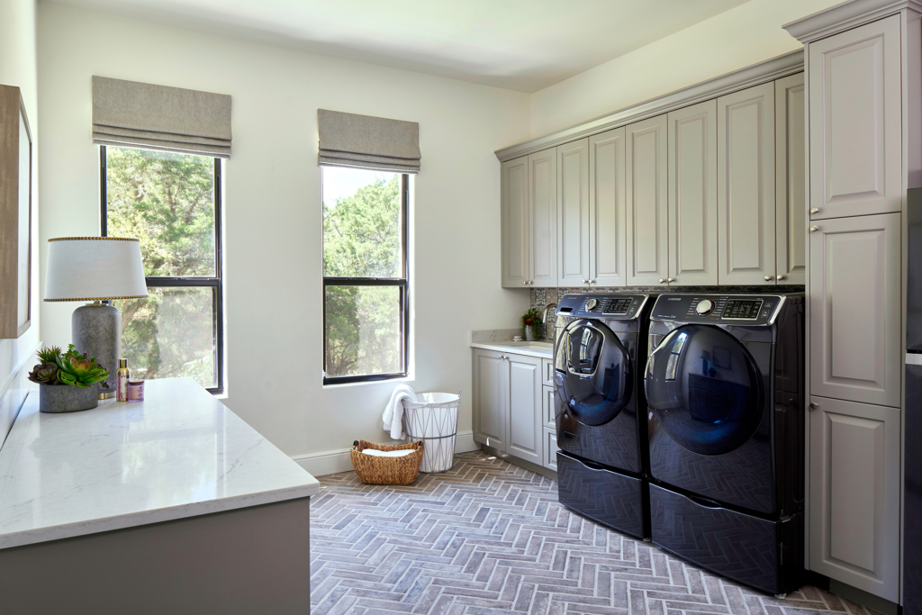 Laundry room cabinets painted in Benjamin Moore’s "River Reflections" give the room a soothing vibe.