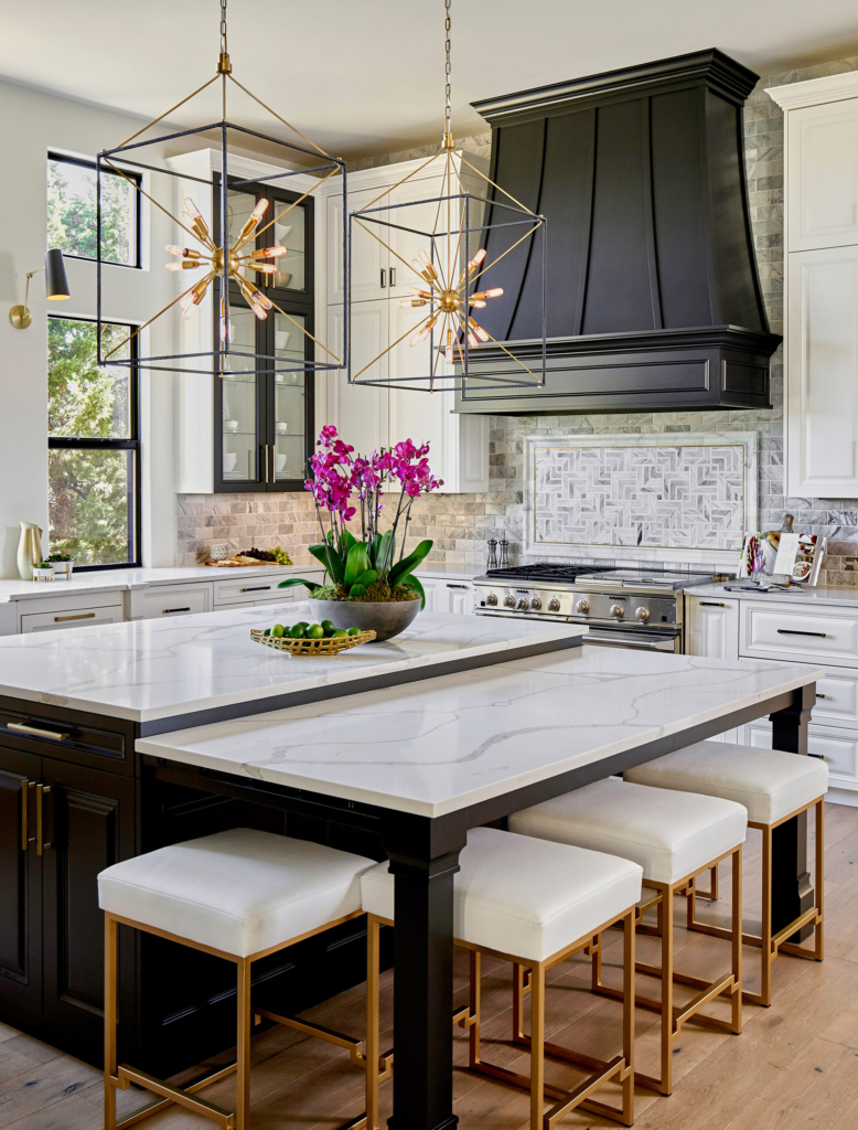 We love the thoughtful details like the two-level island, squared pendants to echo the kitchen's clean lines, and the tile mosaic above the range.