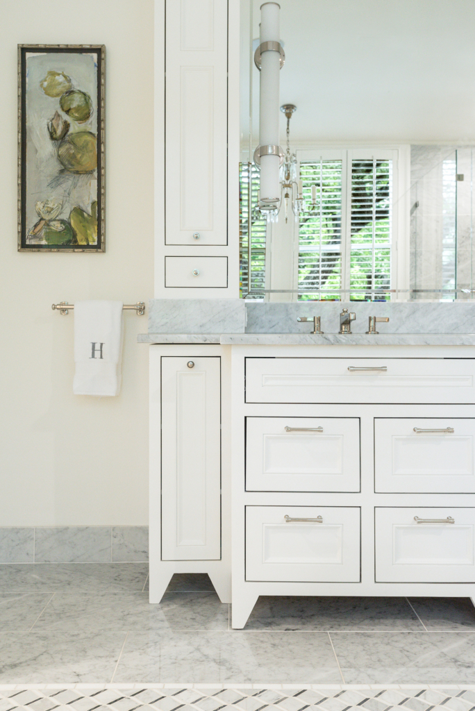Serene and sophisticated, this master bath features custom cabinets and gorgeous tilework.