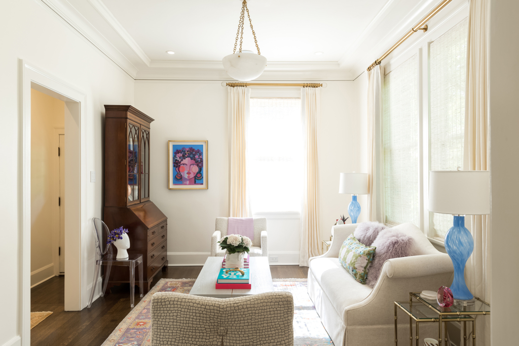 Formal living room with crisp white walls and pastel shades.