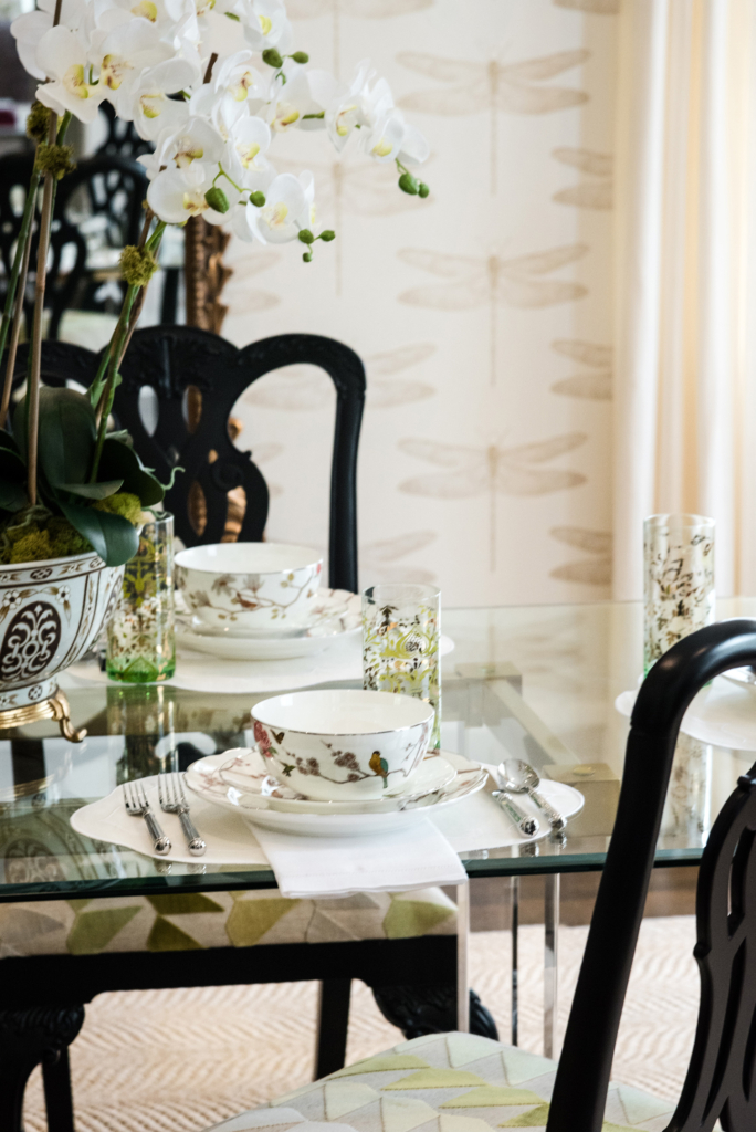 Richly layered place setting's in the elegant wallpapered dining room.