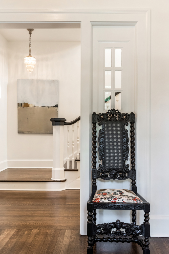 An antique chair perched outside the classic stairwell.