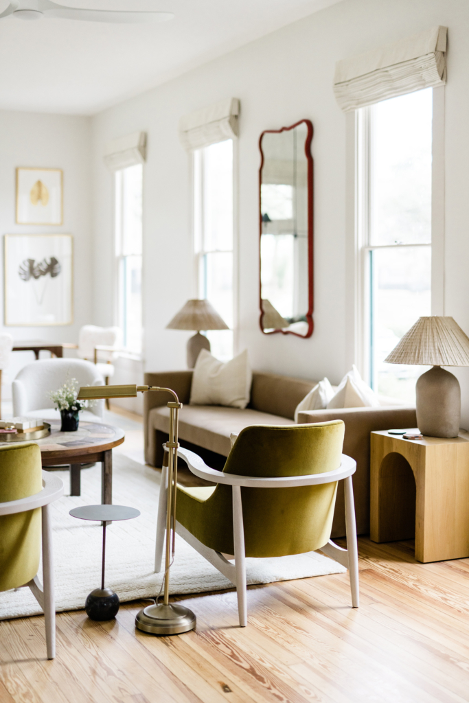 A cozy living room featuring stylish green chairs and a peek toward the sofa. 