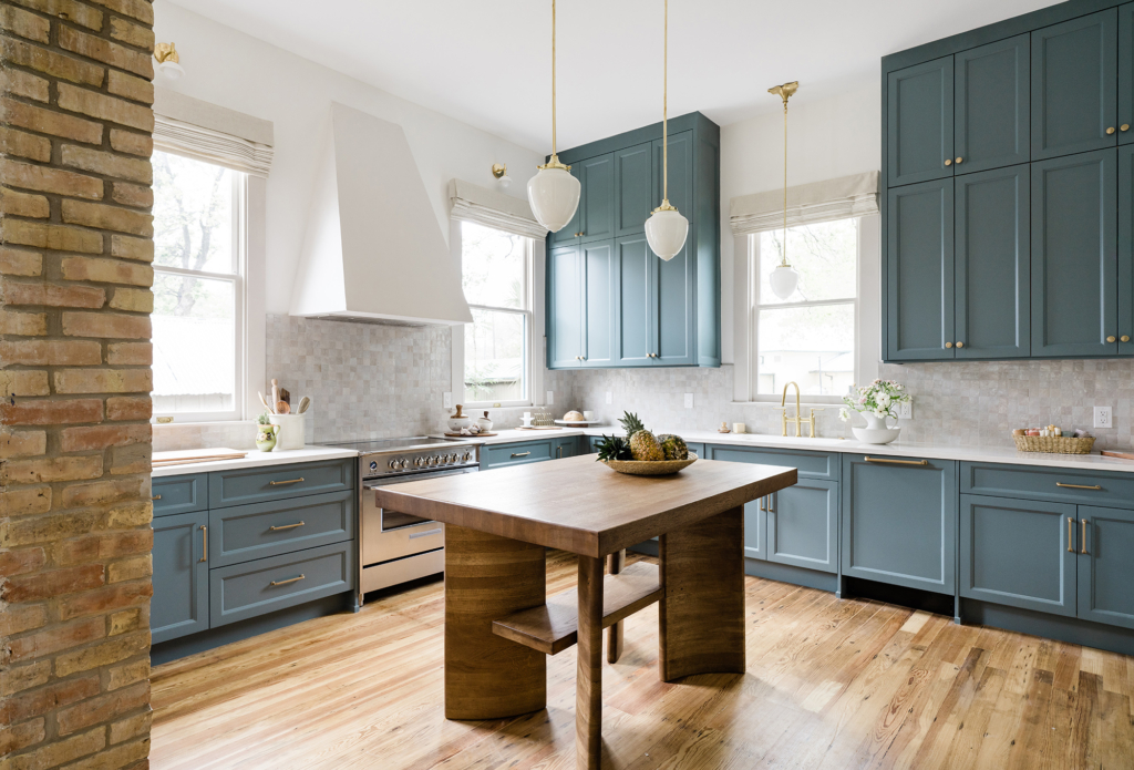 A charming Victorian kitchen featuring bold blue cabinets paired with walls in Farrow & Ball "All White".