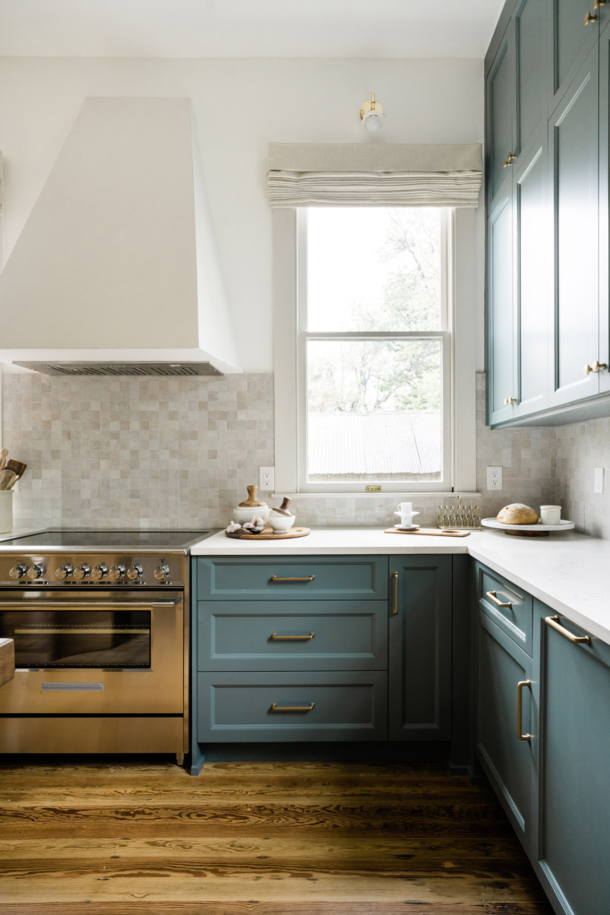 This Victorian-style kitchen renovation features stunning blue cabinets and crisp walls, painted in Farrow & Ball "All White".