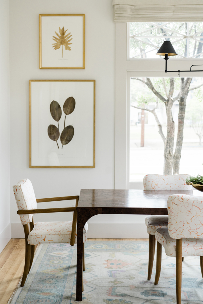 Close-up of the bright and elegant dining room, painted in Farrow & Ball’s “All White”, with "Skimming Stone" on the trim.