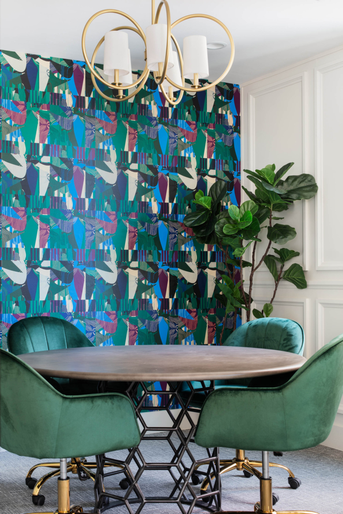 Green chairs and Kristy Stafford's "Basil Green" wallpaper enhance this study and meeting space.