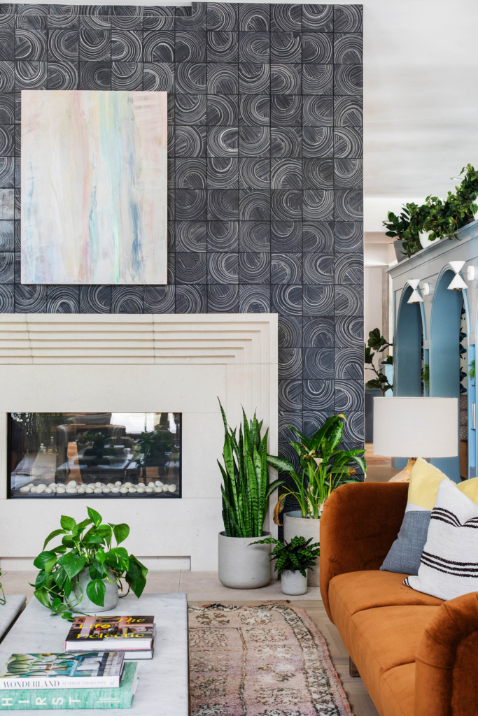Wallpaper by Kristy Stafford enhances the fireplace in another primary lounge area.