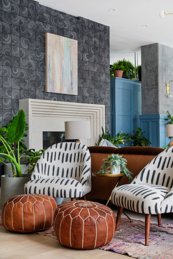 Comfy seating in front of the fireplace accented by Kristy Stafford wallpaper.