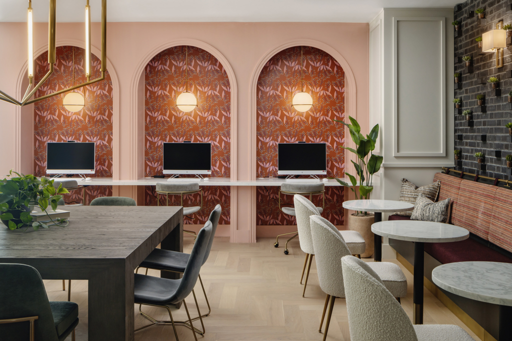 "Dalia Rust" wallpaper by Kristy Stafford add a cozy vibe to this lounge's computer niches.