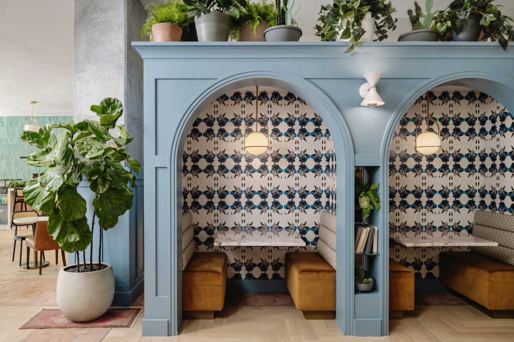 Booth seating brought to life with vibrant "Dragonflower" wallpaper by Kristy Stafford.