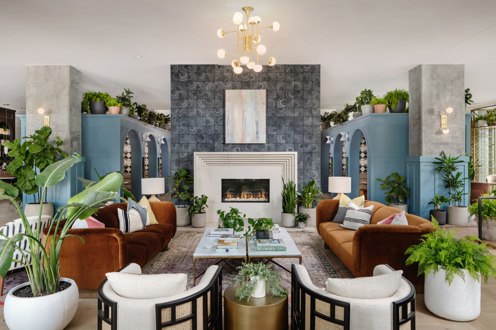 Blue painted built-ins and wallpapers by Kristy Stafford bring energy and color to this lounge.