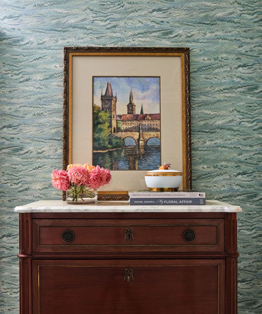 Hall wallpaper in shades of blue and green with console.