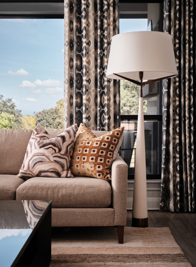 Patterned drapes complement the sofa styling in the living room, adding texture and charm.
