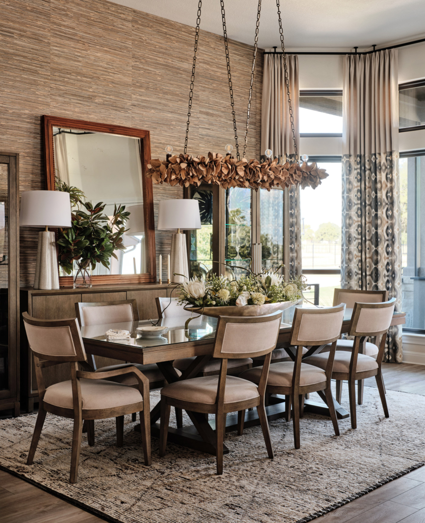 Elegant and textured, this Thibaut "Stablewood" grasscloth wallpaper anchors the warm contemporary dining space.
