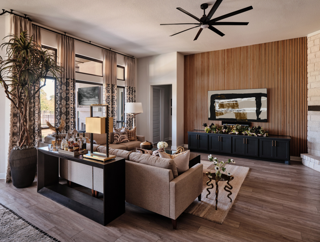 This warm contemporary living room showcases a beautifully crafted wood slat accent wall, adding texture and depth to the space.