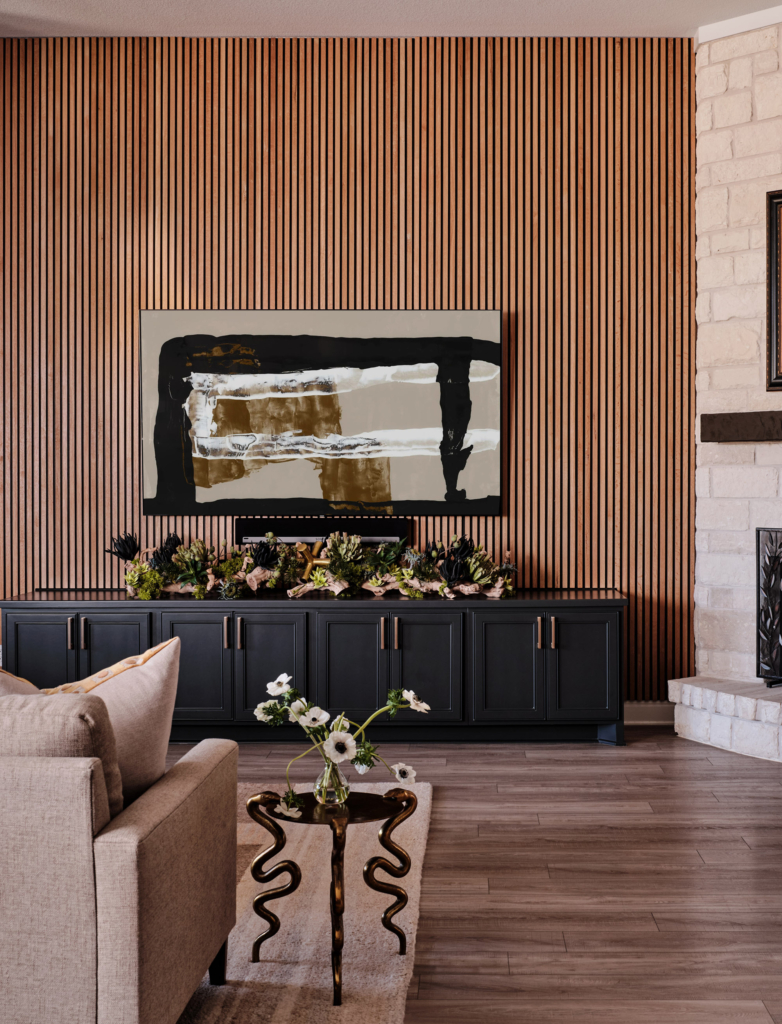A wood slat accent wall brings texture, depth, and contemporary character to this warm living room.