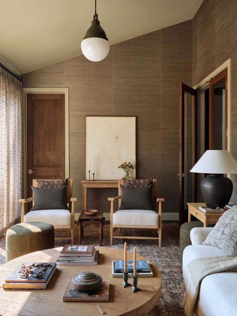 Phillip Jeffries "Juicy Jute" grasscloth wallcovering in the living area lounge, designed by Amber Lewis. A sophisticated texture that creates a cozy and elegant atmosphere.