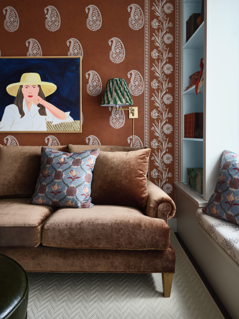 Close-up of the lounge area showcasing Phillip Jeffries custom orange bandana wallpaper with coordinating border, designed by Leah O’Connell. A detailed look at the playful pattern and vibrant color.