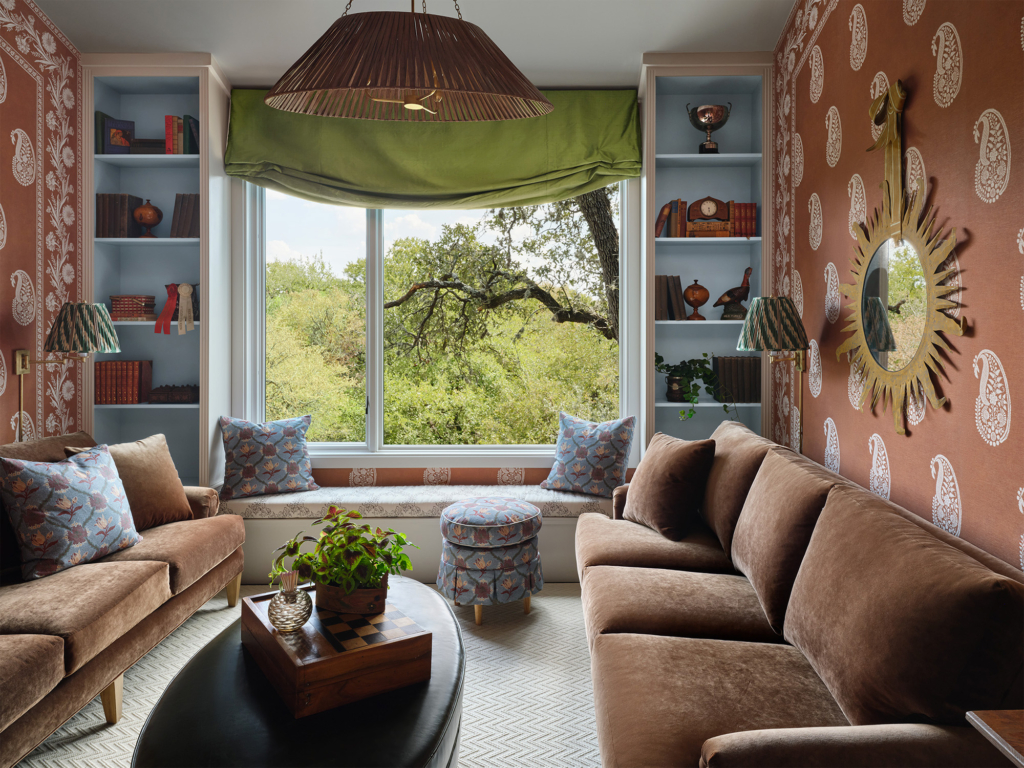 Phillip Jeffries custom orange bandana wallpaper and border define the lounge area in this guest space designed by Leah O’Connell. A lively, whimsical touch that brings energy and charm to the space.