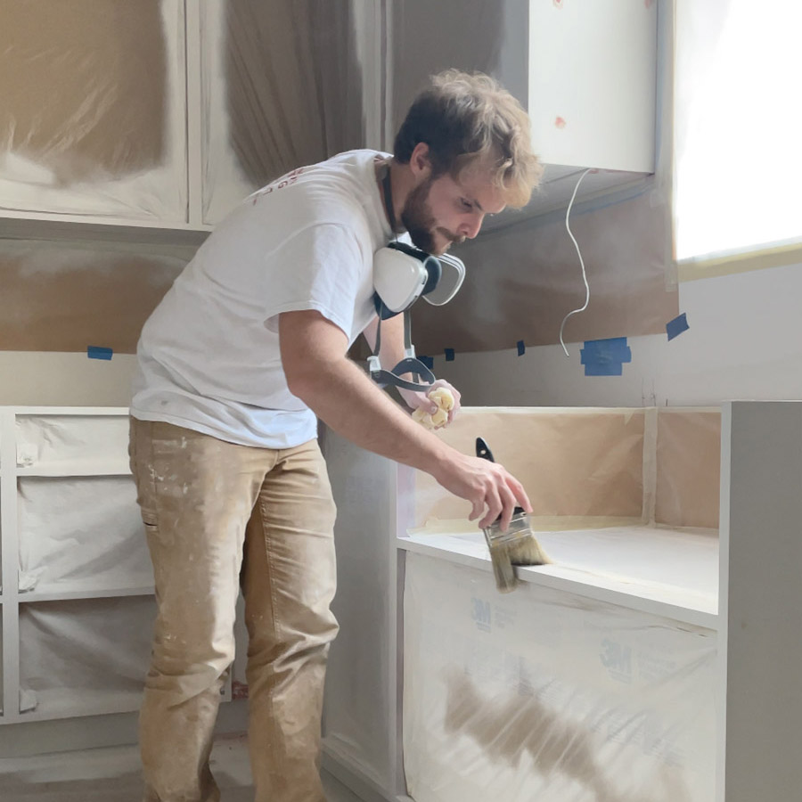 Interior Painting 3 cabinet-painter-dusting-off-primed-cabinets-austin-tx